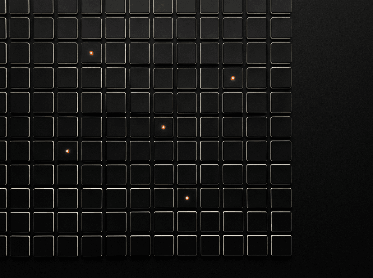 A dark grid of module tiles with three lit orange